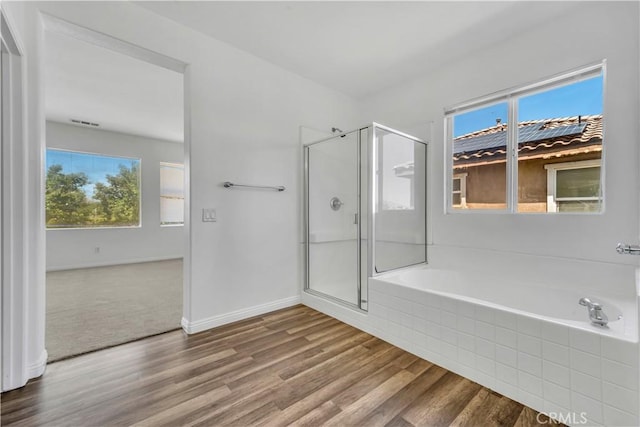 43629 Rucker Ct, Lancaster, CA 93535 - bathroom featuring a stall shower, a wealth of natural light, a garden tub, and wood finished floors
