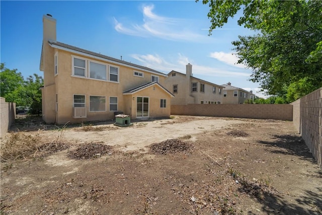 43629 Rucker Ct, Lancaster, CA 93535 - back of property with a fenced backyard, stucco siding, a chimney, and central AC