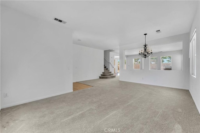 43629 Rucker Ct, Lancaster, CA 93535 - unfurnished living room featuring stairs, baseboards, visible vents, carpet floors, and a notable chandelier
