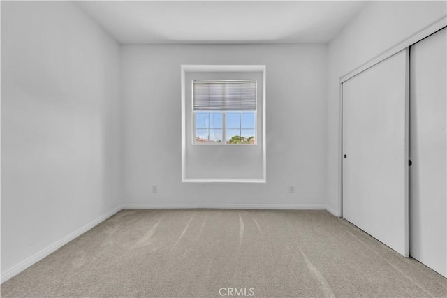 43629 Rucker Ct, Lancaster, CA 93535 - unfurnished bedroom with baseboards, a closet, and carpet