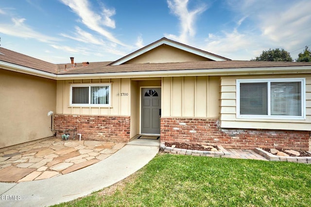 1700 Arlene Ave, Oxnard, CA 93036 - doorway to property with brick siding, board and batten siding, and a shingled roof