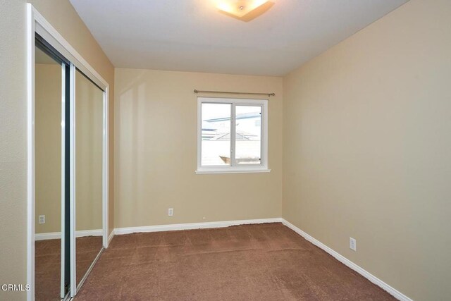 1700 Arlene Ave, Oxnard, CA 93036 - unfurnished bedroom featuring dark carpet, baseboards, and a closet