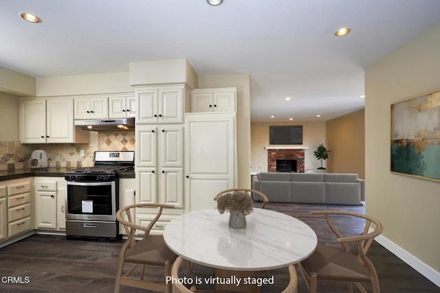 1700 Arlene Ave, Oxnard, CA 93036 - dining room with dark wood-style floors, baseboards, recessed lighting, and a brick fireplace