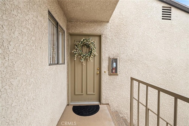 property entrance featuring stucco siding