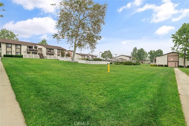 view of yard with a residential view and fence