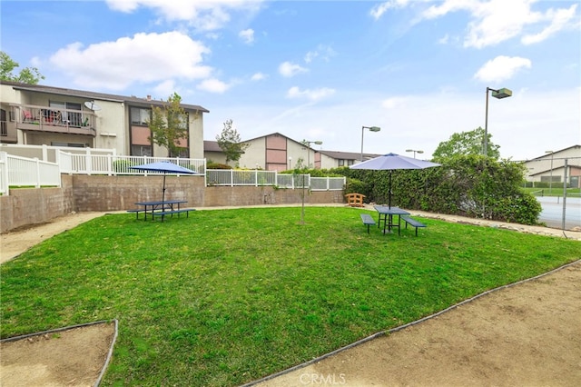 surrounding community featuring a yard and fence