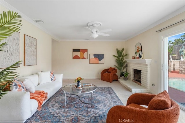 35230 San Carlos St, Yucaipa, CA 92399 - carpeted living area with ornamental molding, a brick fireplace, a ceiling fan, and visible vents