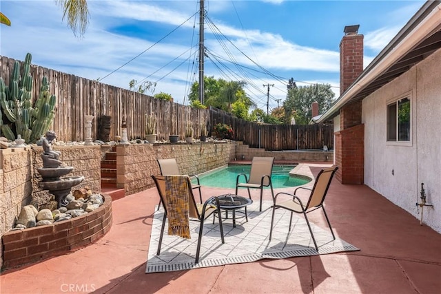 35230 San Carlos St, Yucaipa, CA 92399 - view of patio featuring a fenced backyard, a fenced in pool, and a fire pit