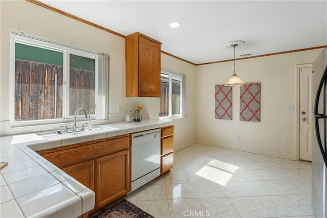 35230 San Carlos St, Yucaipa, CA 92399 - kitchen with dishwasher, tile countertops, brown cabinets, and a sink