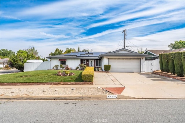 35230 San Carlos St, Yucaipa, CA 92399 - ranch-style home featuring concrete driveway, a front yard, an attached garage, and fence
