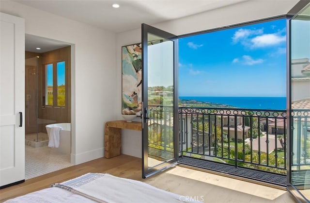 4 Sunset Cv, Newport Coast, CA 92657 - bedroom with recessed lighting, baseboards, a water view, connected bathroom, and wood finished floors
