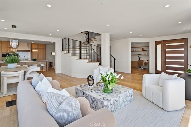 4 Sunset Cv, Newport Coast, CA 92657 - living room with light wood-type flooring, stairway, baseboards, and recessed lighting
