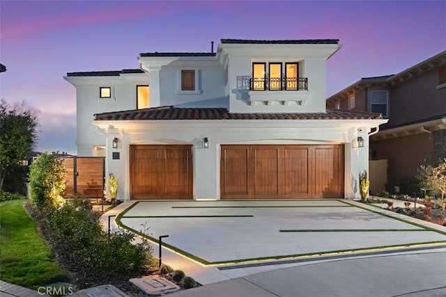4 Sunset Cv, Newport Coast, CA 92657 - mediterranean / spanish-style home with a balcony, stucco siding, a tiled roof, and an attached garage