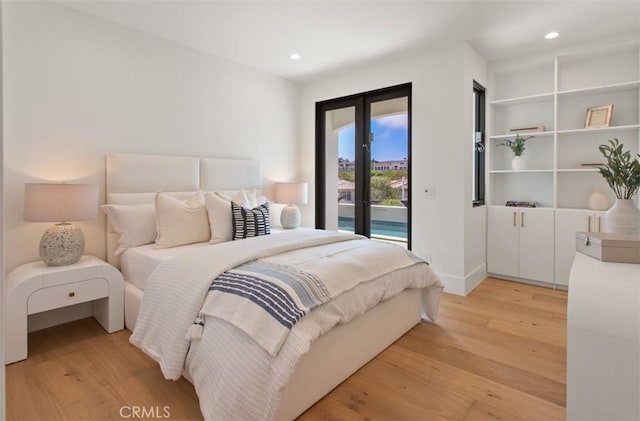 4 Sunset Cv, Newport Coast, CA 92657 - bedroom with light wood-style floors, french doors, recessed lighting, and access to exterior