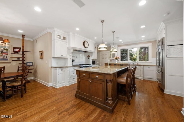 kitchen featuring dark wood finished floors, white cabinets, and recessed lighting