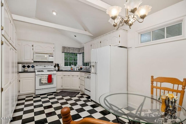 kitchen with white cabinetry, white appliances, a notable chandelier, and dark countertops