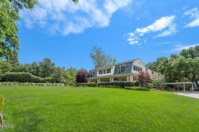 exterior space featuring a front lawn and a chimney