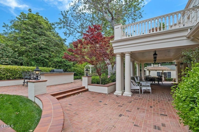 view of patio / terrace with area for grilling, outdoor dining area, and a balcony