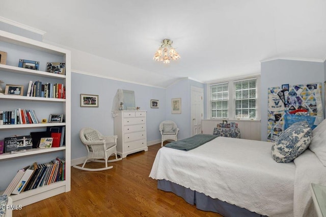 bedroom with ornamental molding, a notable chandelier, baseboards, and wood finished floors