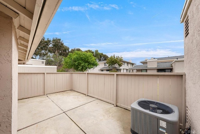 view of patio / terrace featuring central air condition unit and fence
