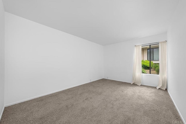 empty room with carpet flooring and baseboards