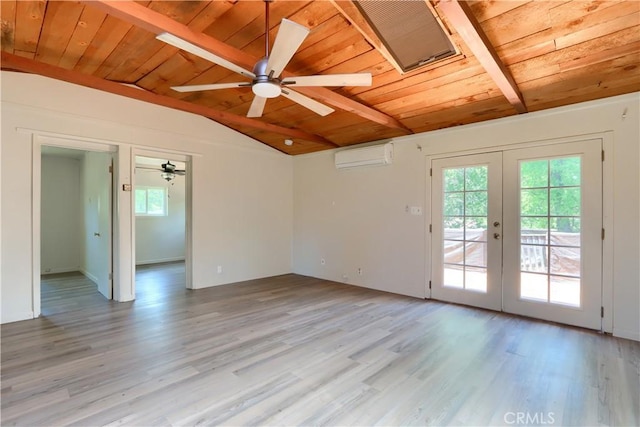 spare room with a healthy amount of sunlight, french doors, vaulted ceiling with beams, and an AC wall unit