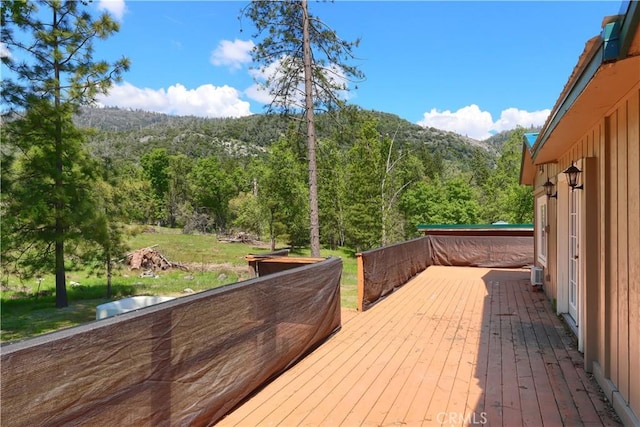 deck featuring a view of trees and a mountain view