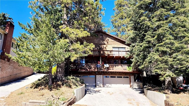 31194 Outer Highway 18 N, Running Springs, CA 92382 - view of front of property featuring a balcony, a garage, and concrete driveway