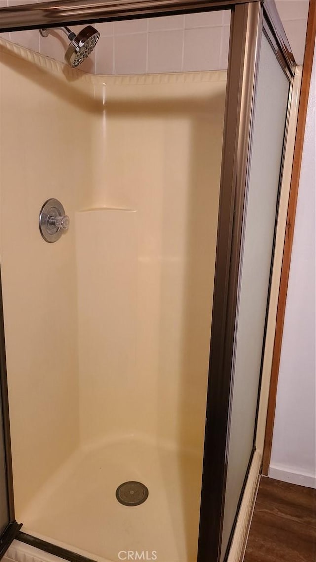 31194 Outer Highway 18 N, Running Springs, CA 92382 - full bathroom featuring a stall shower and wood finished floors