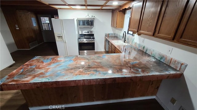 31194 Outer Highway 18 N, Running Springs, CA 92382 - kitchen featuring appliances with stainless steel finishes, a sink, a peninsula, light countertops, and dark wood-type flooring