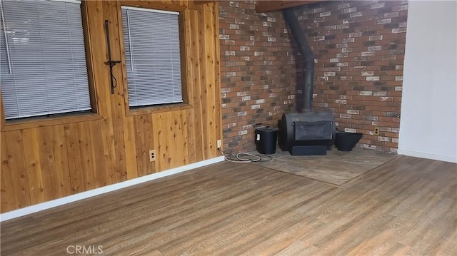 31194 Outer Highway 18 N, Running Springs, CA 92382 - unfurnished living room with baseboards, wood finished floors, a wood stove, and wood walls