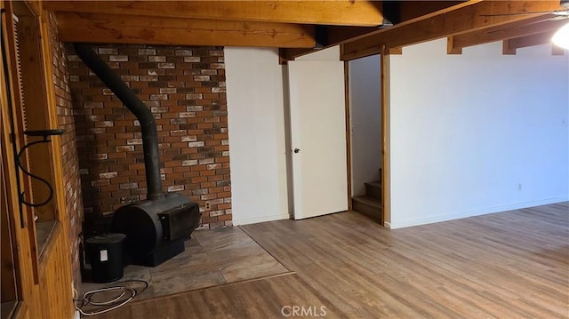31194 Outer Highway 18 N, Running Springs, CA 92382 - basement with wood finished floors, a wood stove, baseboards, and stairs