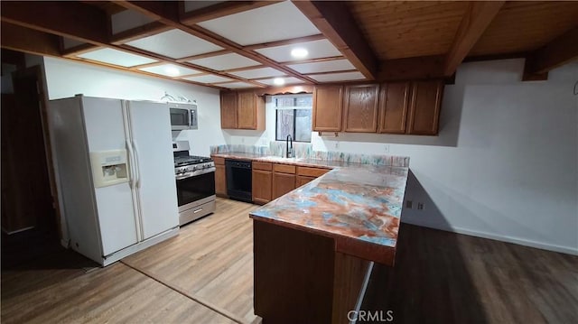31194 Outer Highway 18 N, Running Springs, CA 92382 - kitchen featuring appliances with stainless steel finishes, light wood-style floors, a sink, light countertops, and brown cabinetry