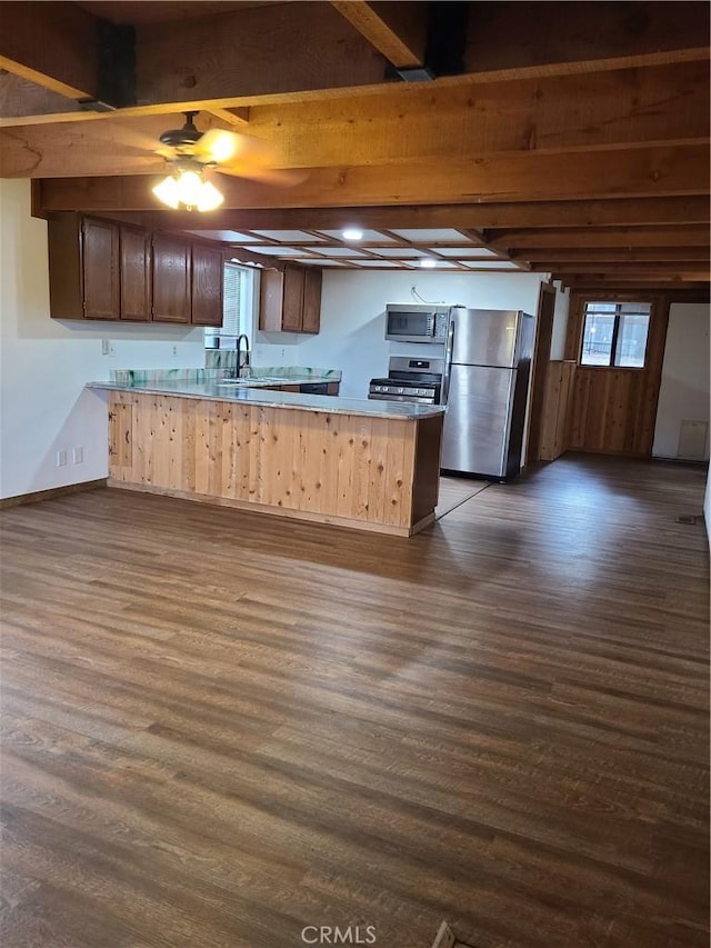 31194 Outer Highway 18 N, Running Springs, CA 92382 - kitchen featuring appliances with stainless steel finishes, a peninsula, dark wood-type flooring, and healthy amount of natural light