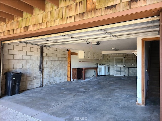 31194 Outer Highway 18 N, Running Springs, CA 92382 - garage featuring a garage door opener, concrete block wall, and washer and clothes dryer