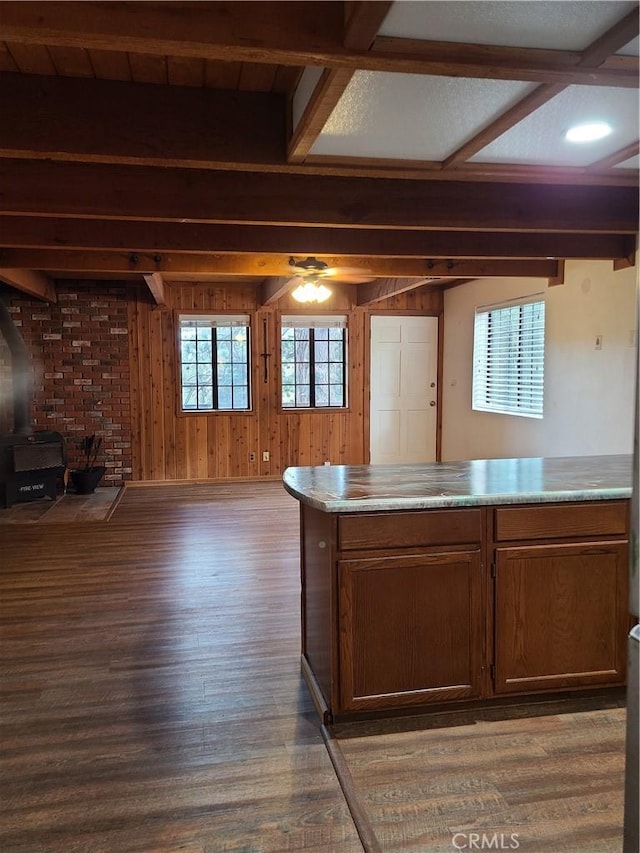 31194 Outer Highway 18 N, Running Springs, CA 92382 - kitchen featuring wood finished floors, beam ceiling, a wood stove, wood walls, and open floor plan