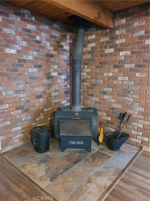31194 Outer Highway 18 N, Running Springs, CA 92382 - detailed view of a wood stove, brick wall, and wood finished floors