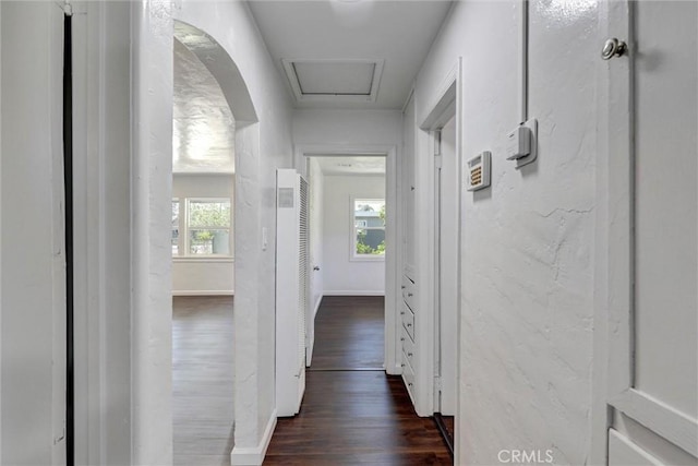 3001 N State St, San Bernardino, CA 92407 - hallway with arched walkways, dark wood-style flooring, a heating unit, and plenty of natural light