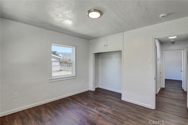 3001 N State St, San Bernardino, CA 92407 - unfurnished bedroom with a closet, dark wood finished floors, and baseboards