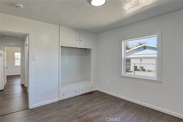 3001 N State St, San Bernardino, CA 92407 - unfurnished bedroom featuring multiple windows, dark wood-type flooring, and baseboards