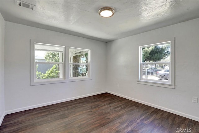 3001 N State St, San Bernardino, CA 92407 - empty room featuring visible vents, baseboards, and dark wood-style floors