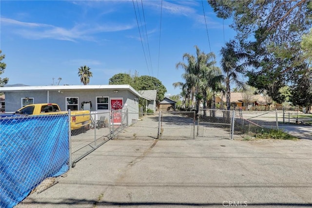 3001 N State St, San Bernardino, CA 92407 - view of front of home featuring stucco siding, fence private yard, and a gate