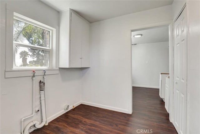 3001 N State St, San Bernardino, CA 92407 - laundry room featuring cabinet space, dark wood-style flooring, and baseboards