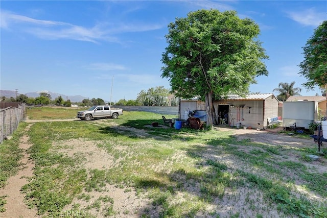 3001 N State St, San Bernardino, CA 92407 - view of yard featuring fence, a mountain view, and an outbuilding