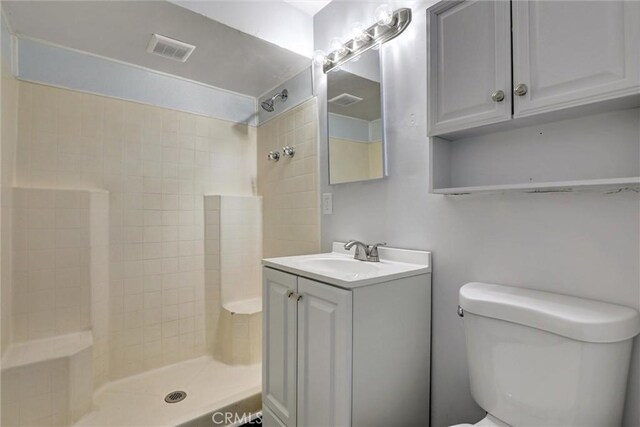 3001 N State St, San Bernardino, CA 92407 - bathroom with vanity, toilet, visible vents, and tiled shower