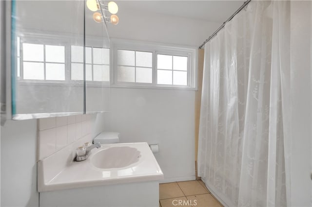 bathroom featuring vanity, curtained shower, and tile patterned floors