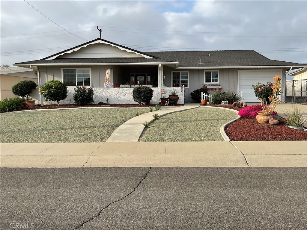 view of front of property with roof with shingles, concrete driveway, and a garage