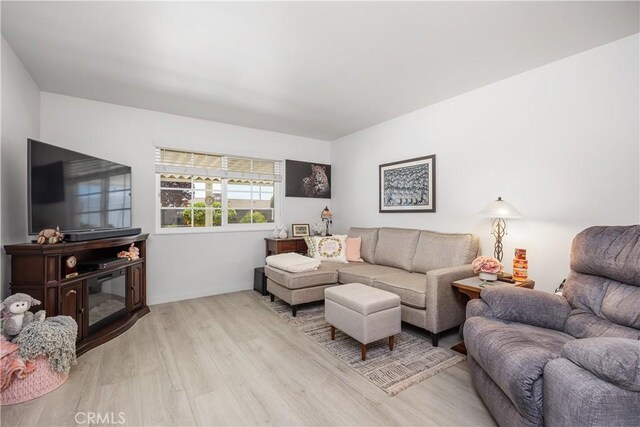 25805 Musselburgh Dr, Menifee, CA 92586 - living room featuring light wood-style floors and baseboards