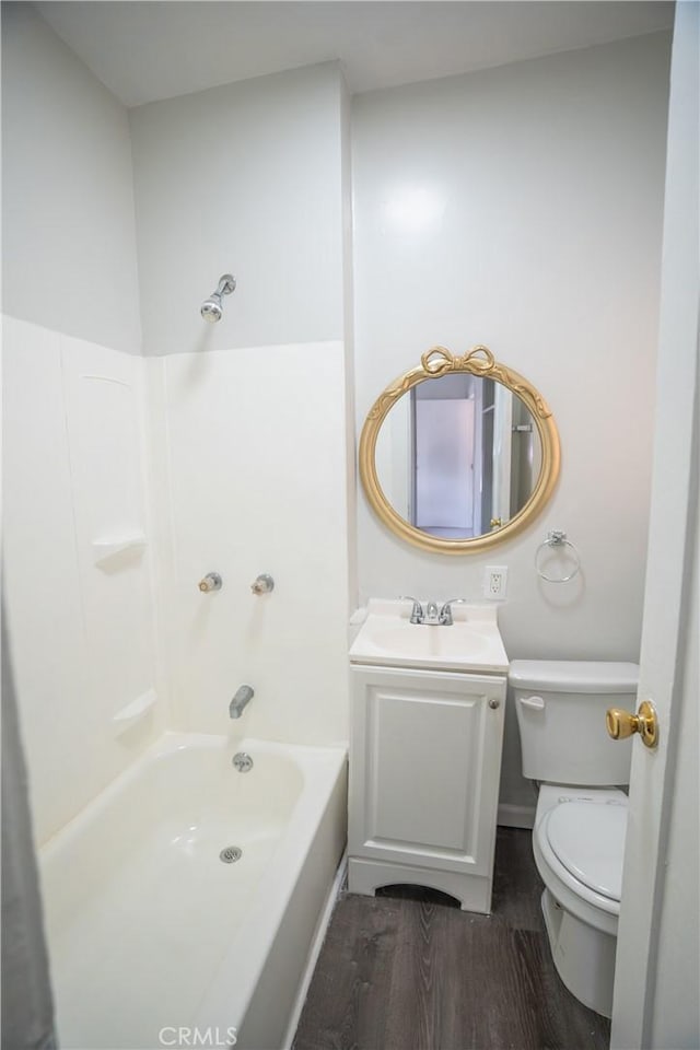 bathroom featuring toilet, shower / bath combination, vanity, and wood finished floors