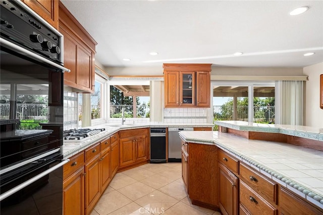 1206 Arno Dr, Sierra Madre, CA 91024 - kitchen with stainless steel appliances, brown cabinets, decorative backsplash, a sink, and recessed lighting